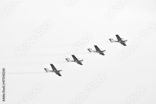 Four antique airplane flying during a grey day