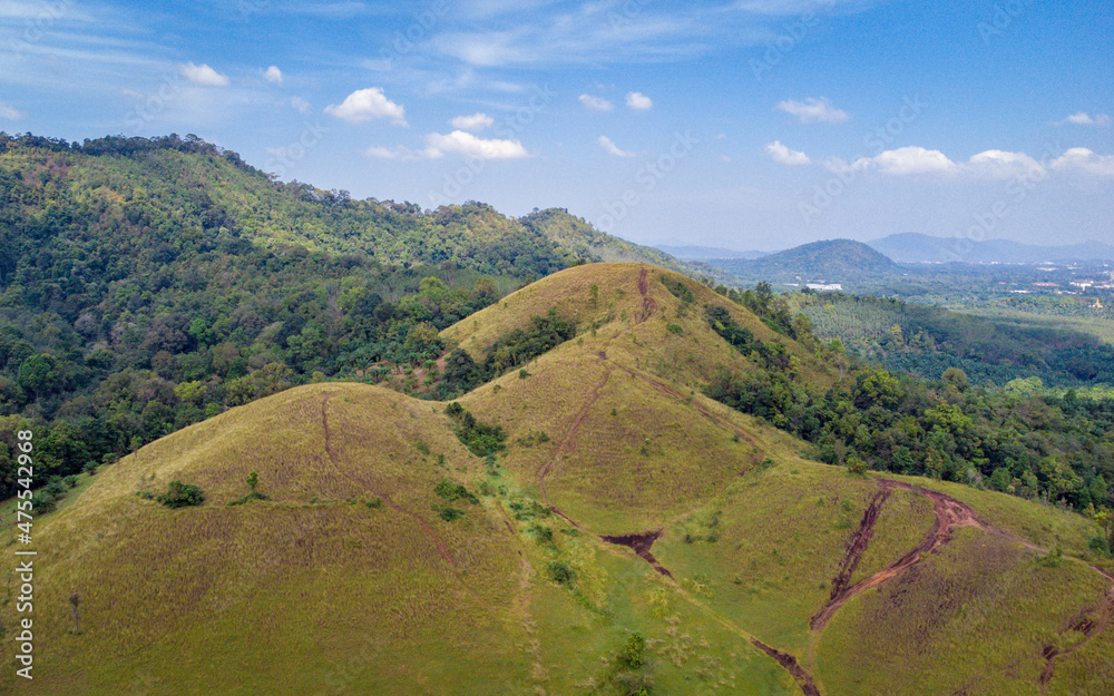bald mountain or Phu Khao Ya with green grass field and blue sky. One of natural travel attraction in Ranong province, Thailand
