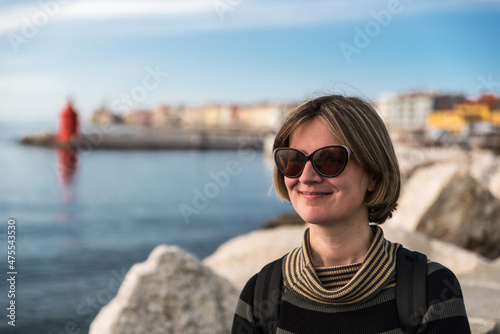 Holiday portrait of a smiling 30 year old white woman at the seaside, Piran, Slovenia © Werner