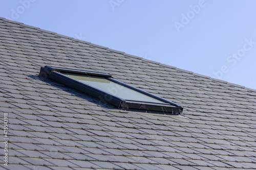 Closeup shot of a skylight or Velux window on a slate roof photo