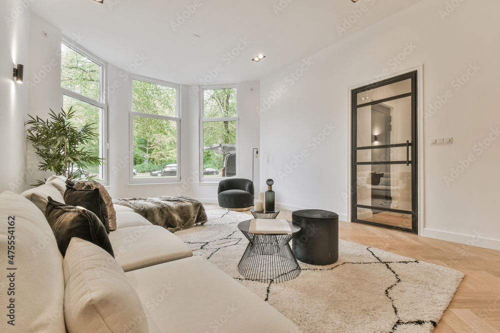 Spacious living room interior with sofa and arched window Spacious living room interior with sofa and arched window
