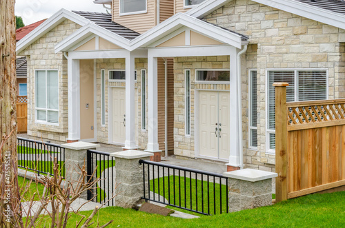 A perfect neighborhood. Houses in suburb at Spring in the north America. Fragment of a luxury house with nice window.