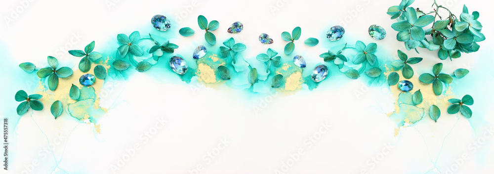 Creative image of emerald and green Hydrangea flowers on artistic ink background. Top view with copy space Creative image of emerald and green Hydrangea flowers on artistic ink background. Top view with copy space