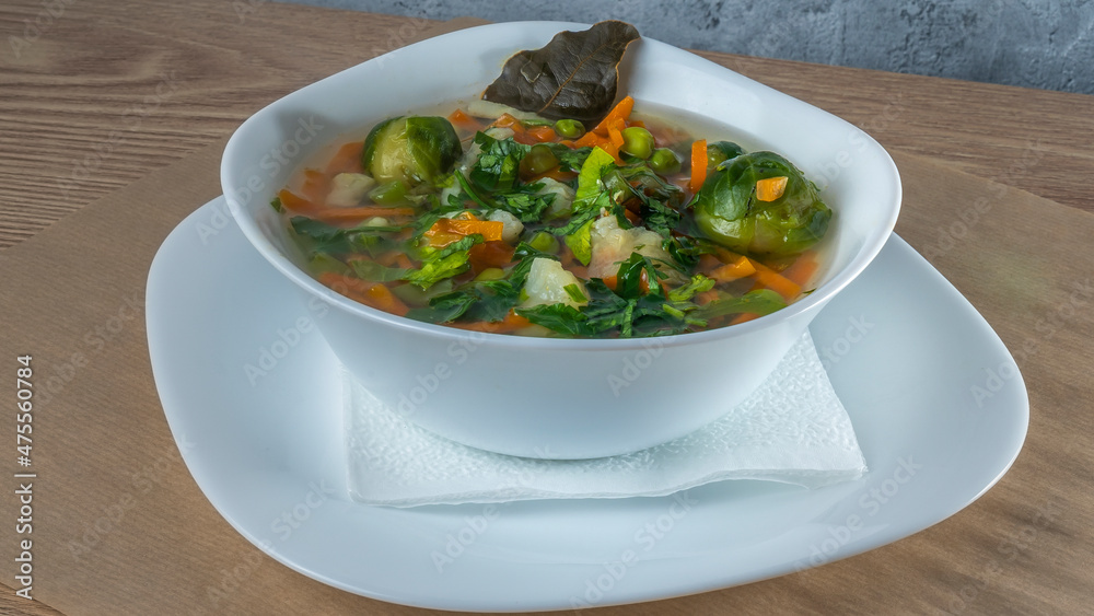 Fresh vegetable soup made of green bean, pea, carrot, potato, red bell pepper, tomato and leek in bowl. Fresh vegetable soup made of green bean, pea, carrot, potato, red bell pepper, tomato and leek in bowl.