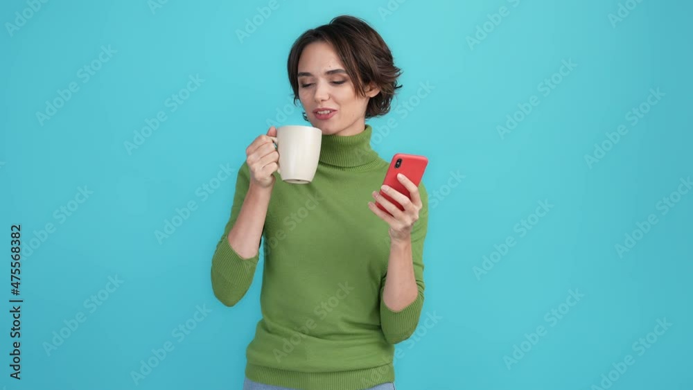 Lady use gadget drink beverage social media isolated blue color background Lady use gadget drink beverage social media isolated blue color background