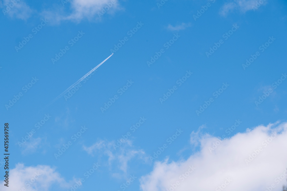 Airplane flying through the sky leaving a white trail through the clouds. Airplane flying through the sky leaving a white trail through the clouds.