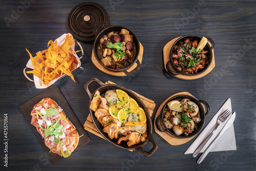 Traditional portuguese cuisine dishes of meat and fish products on a wooden table flat lay view photo