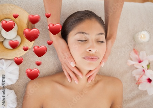 Multiple red heart icons against woman receiving a neck massage at a spa
