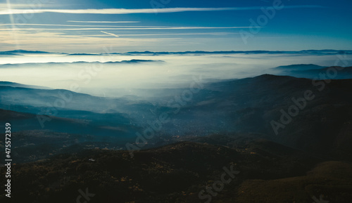 Mountain view with mist over them. Stunning view with blue sky, bright shining sun and white clouds. Bulgarian nature. High quality photo © Viktorio