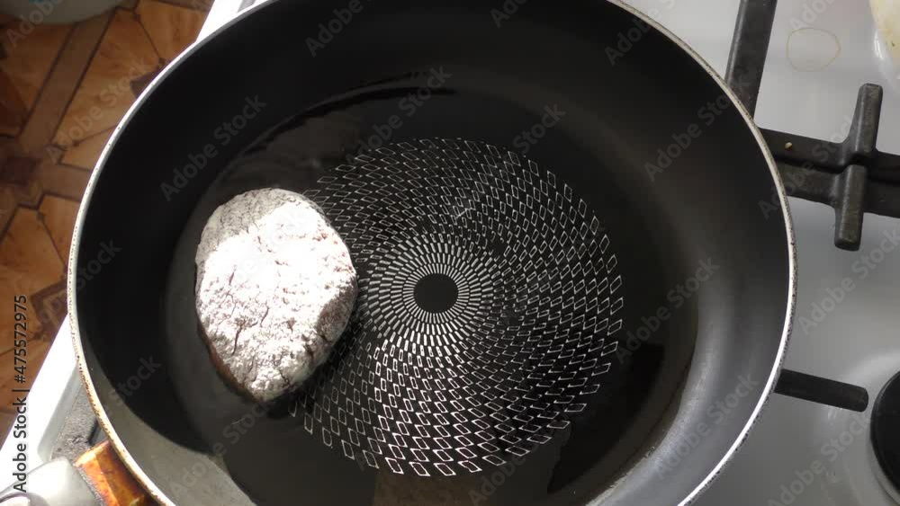 the chef fries meat patties in a pan 