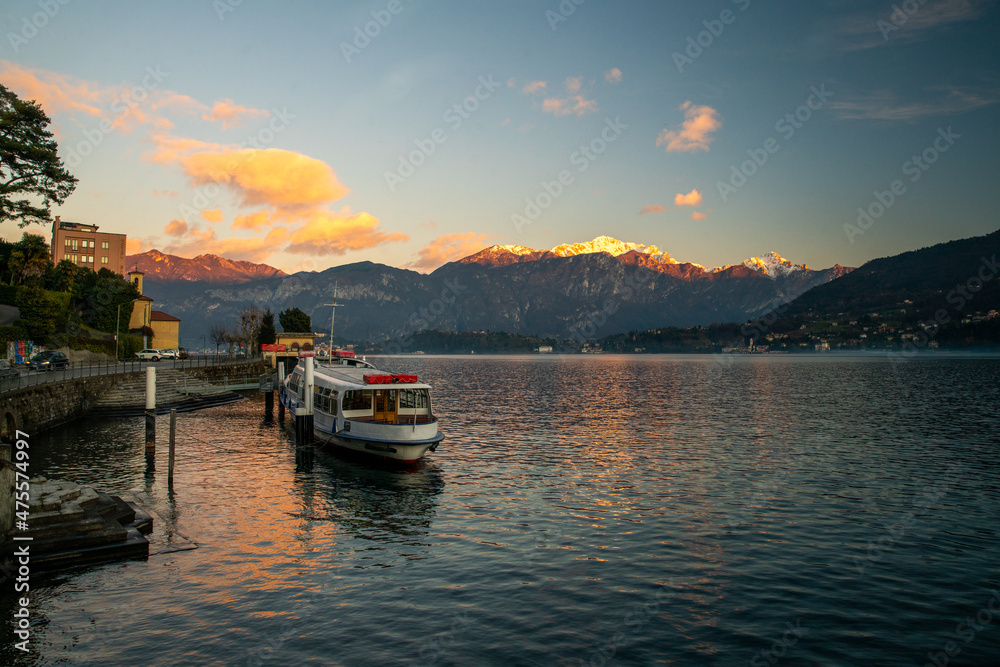 Amazing sunset on lakr Como in winter during Christmas holidays  with snow capped mountains