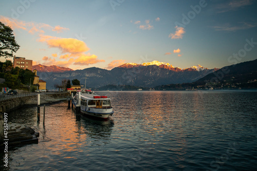 Amazing sunset on lakr Como in winter during Christmas holidays  with snow capped mountains © Marat Lala