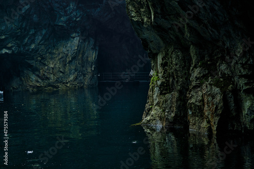 picturesque cave with water in summer