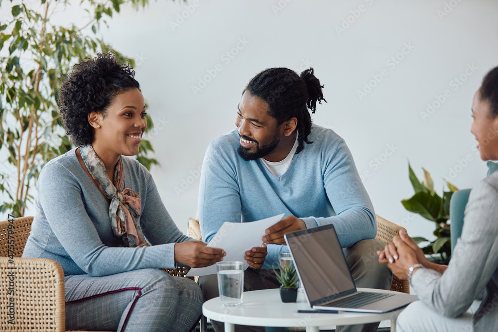 Happy black couple having meeting with their financial advisor in office. Happy black couple having meeting with their financial advisor in office.