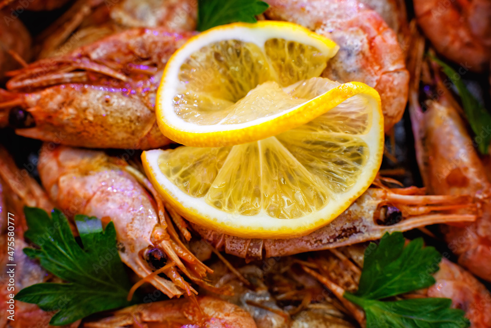 Selective focus. Close-up of shrimp with lemon on a wooden background Selective focus. Close-up of shrimp with lemon on a wooden background