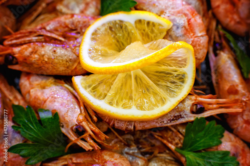 Selective focus. Close-up of shrimp with lemon on a wooden background
