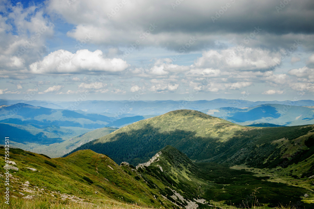 Incredibly beautiful panoramic views of the Carpathian Mountains. Peaks in the Carpathians on a background of blue sky.