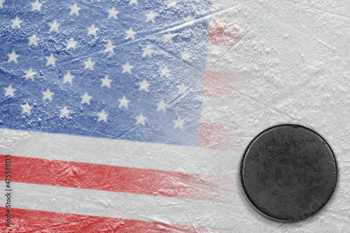 Hockey puck lying on the ice of the arena with the image of the American flag