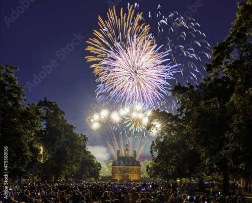 Fotografia, Obraz Crowd enjoying a beautiful view of fireworks over Governor's Palace in Williamsb