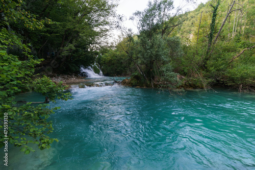 Beautiful turquoise river with waterfall surrounded by forest in Plitvice Lakes National Park  Croatia