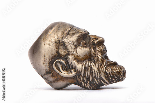 The figure of a bearded screaming man made of bronze