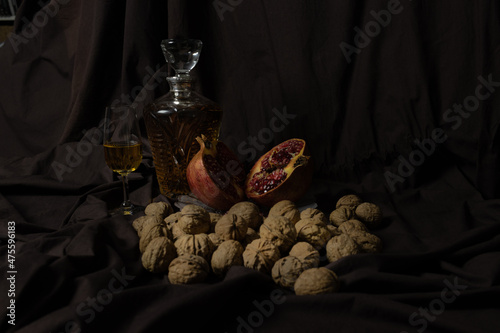 Still life composed of walnuts, pomegranate and muscat wine photo