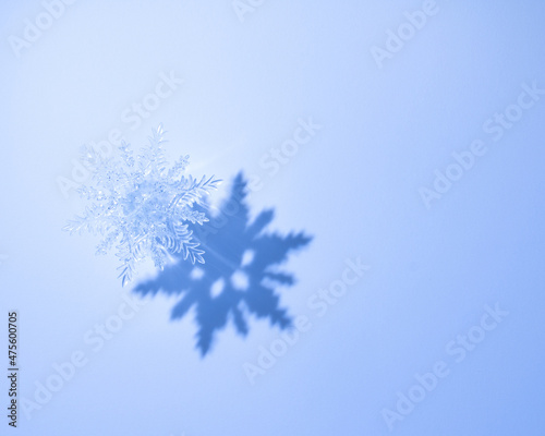 Crystal snowflake Isolated on blue gradient background with shadow. Decorative Snowflake for Christmas, New Year, and Winter Holidays Decoration, Print, Greeting Card, Invitation, Party Flyer, etc.