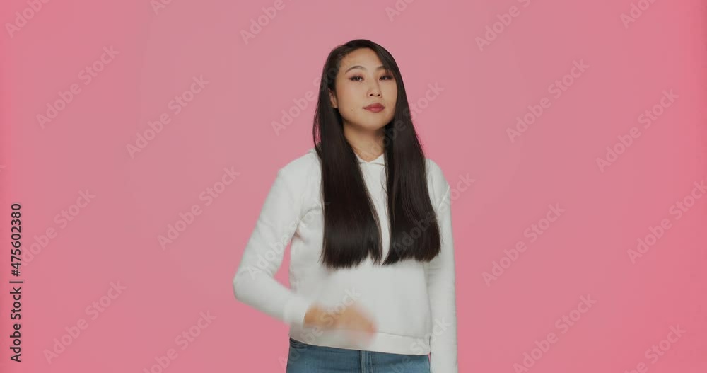 Asian young girl show stop gesture, say no, protest against bullying attacks, racial discrimination on pink background Asian young girl show stop gesture, say no, protest against bullying attacks, racial discrimination on pink background