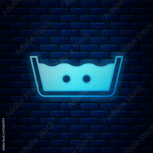 Glowing neon Washing under 40 degrees celsius icon isolated on brick wall background. Temperature wash. Vector