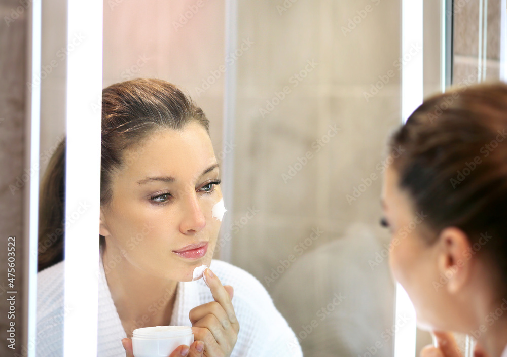 Magic anti-aging cream.Applying the cream. Magic anti-aging cream.Applying the cream.
