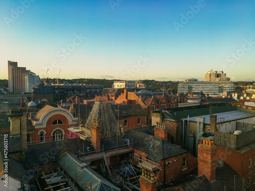 Nottingham cityscape at sunset. Industrial historical English city. Red brick buildings and clear blue sky.