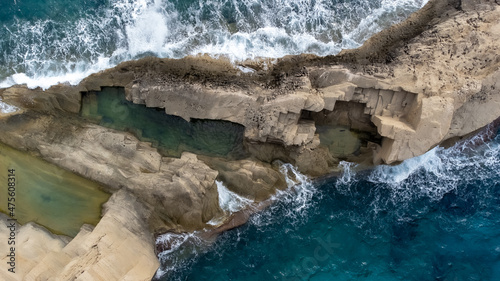 Aerial view of a cliff with a natural pool