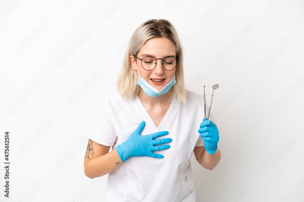 Dentist caucasian woman holding tools isolated on white background smiling a lot Dentist caucasian woman holding tools isolated on white background smiling a lot