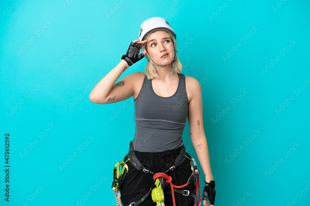 Young caucasian rock-climber woman isolated on white background having doubts and with confuse face expression Young caucasian rock-climber woman isolated on white background having doubts and with confuse face expression