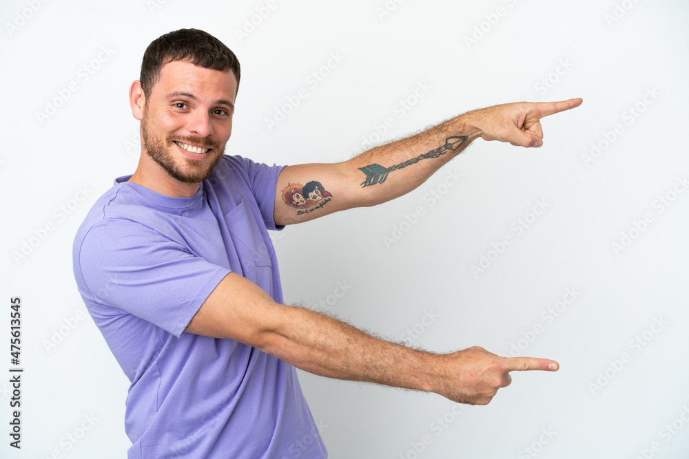 Young Brazilian man isolated on white background pointing finger to the side and presenting a product Young Brazilian man isolated on white background pointing finger to the side and presenting a product