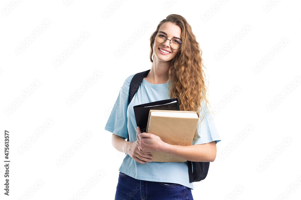 Young smiling student woman holds books while looking at camera. Over white background. Education. - obrazy, fototapety, plakaty 