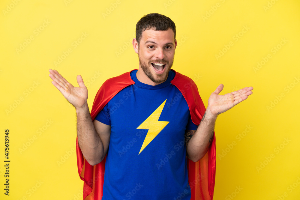 Super Hero Brazilian man isolated on yellow background with shocked facial expression Super Hero Brazilian man isolated on yellow background with shocked facial expression