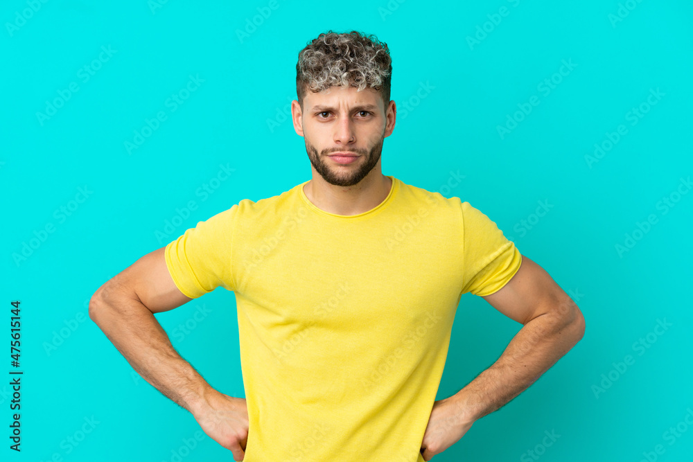 Young handsome caucasian man isolated on blue background angry Young handsome caucasian man isolated on blue background angry