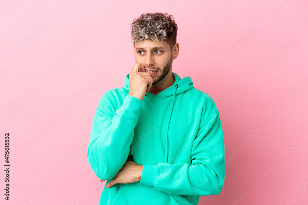 Young handsome caucasian man isolated on pink background nervous and scared Young handsome caucasian man isolated on pink background nervous and scared