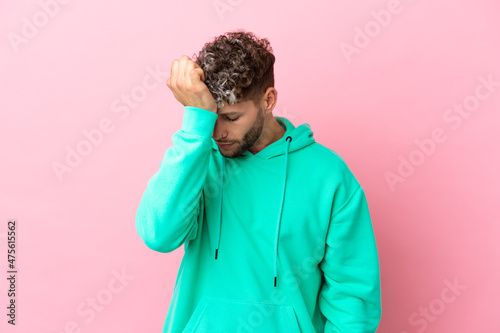 Young handsome caucasian man isolated on pink background with headache © luismolinero
