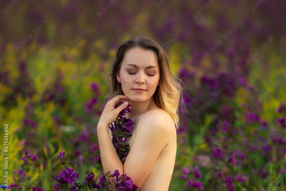 beautiful girl undressed in a flower field. beautiful girl undressed in a flower field.