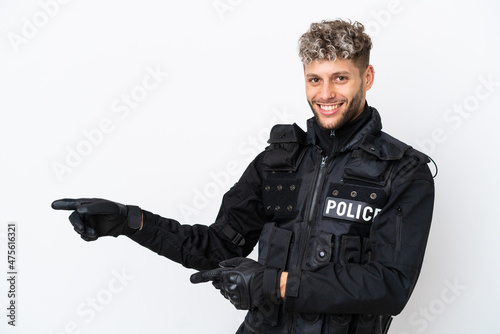 SWAT caucasian man isolated on white background pointing finger to the side and presenting a product