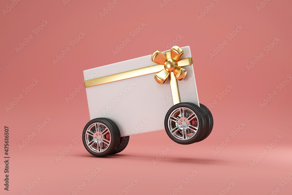 Naklejka premium Gift Card on Wheels with Gold Bow on pink studio background