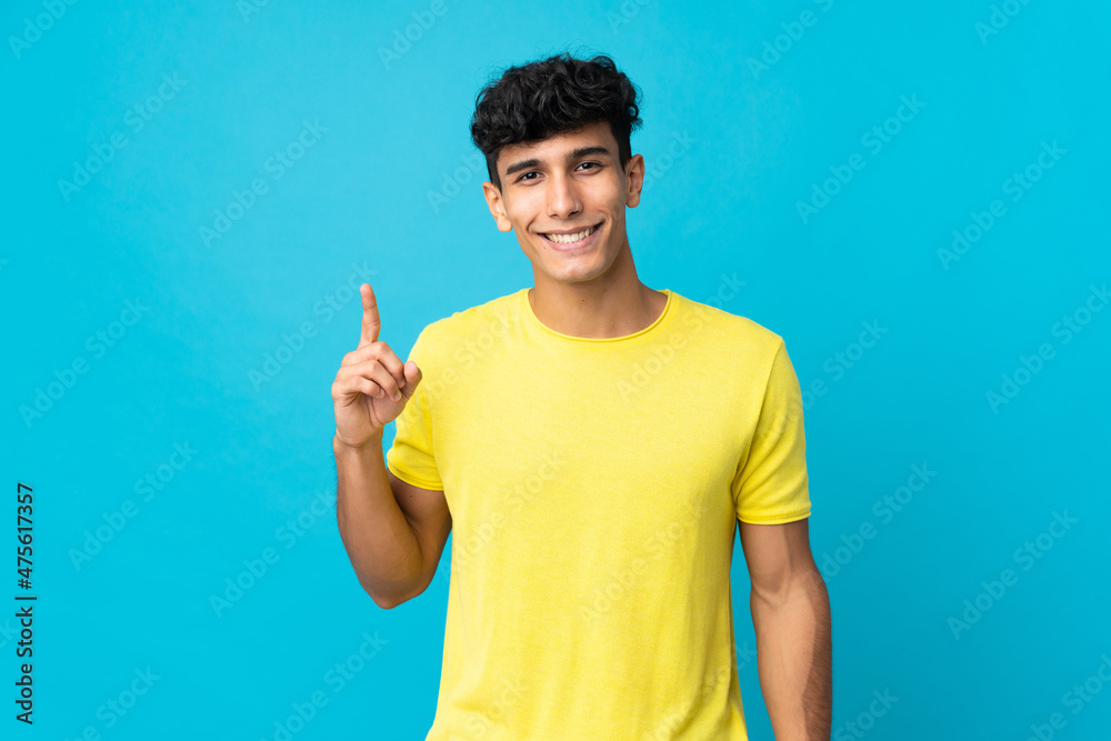 Young Argentinian man isolated on background pointing up a great idea Young Argentinian man isolated on background pointing up a great idea