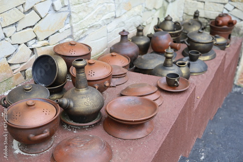 various kinds of ancient pottery from clay and brass photo