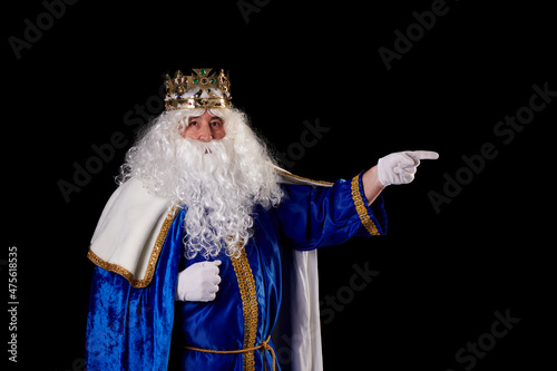 Magician pointing to a billboard on a black background