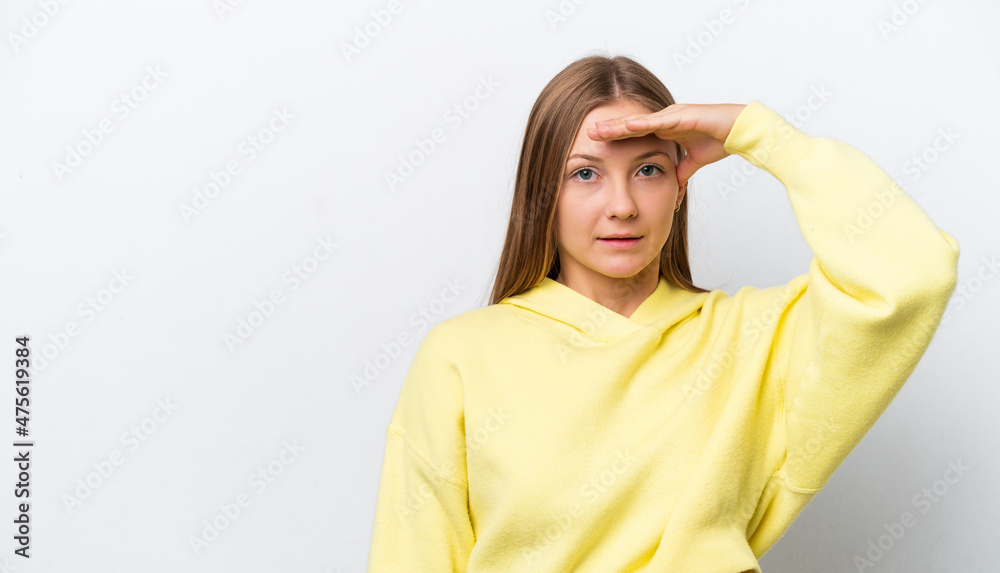 Young Russian woman isolated on white background looking far away with hand to look something Young Russian woman isolated on white background looking far away with hand to look something