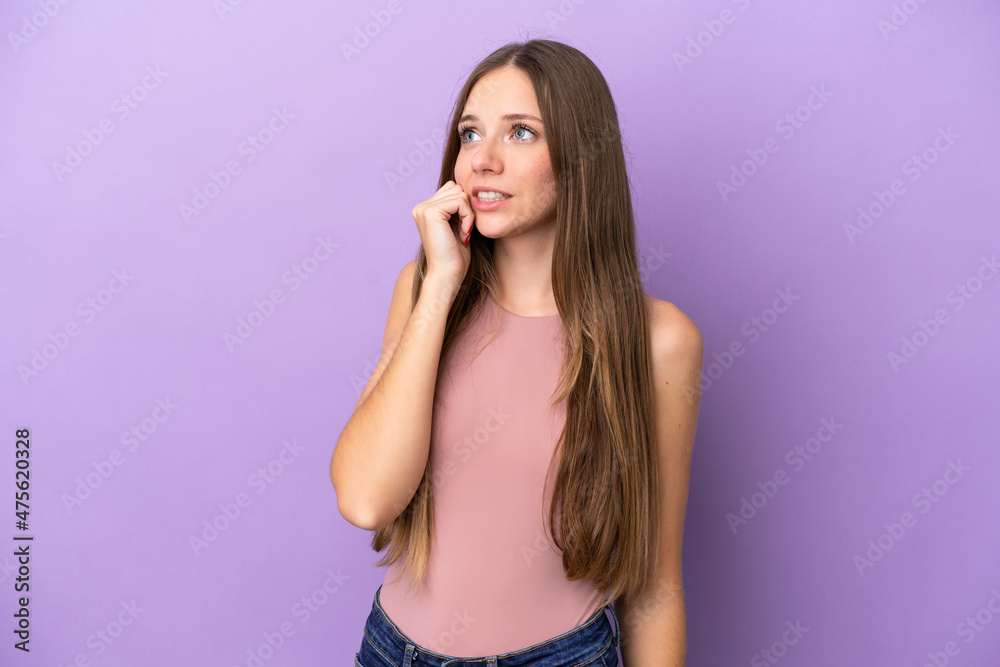 Young Lithuanian woman isolated on purple background is a little bit nervous