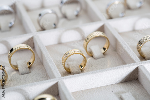 Silver and gold rings on the display in jewelry store