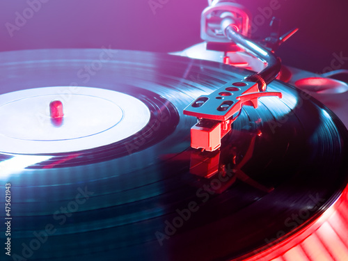 turntable dj  with red and blue light in a club